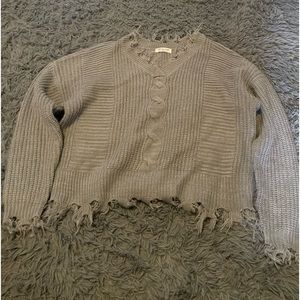 A grey distressed sweater